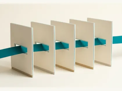 A marine ribbon threading through slots in a row of upright stone cards.
